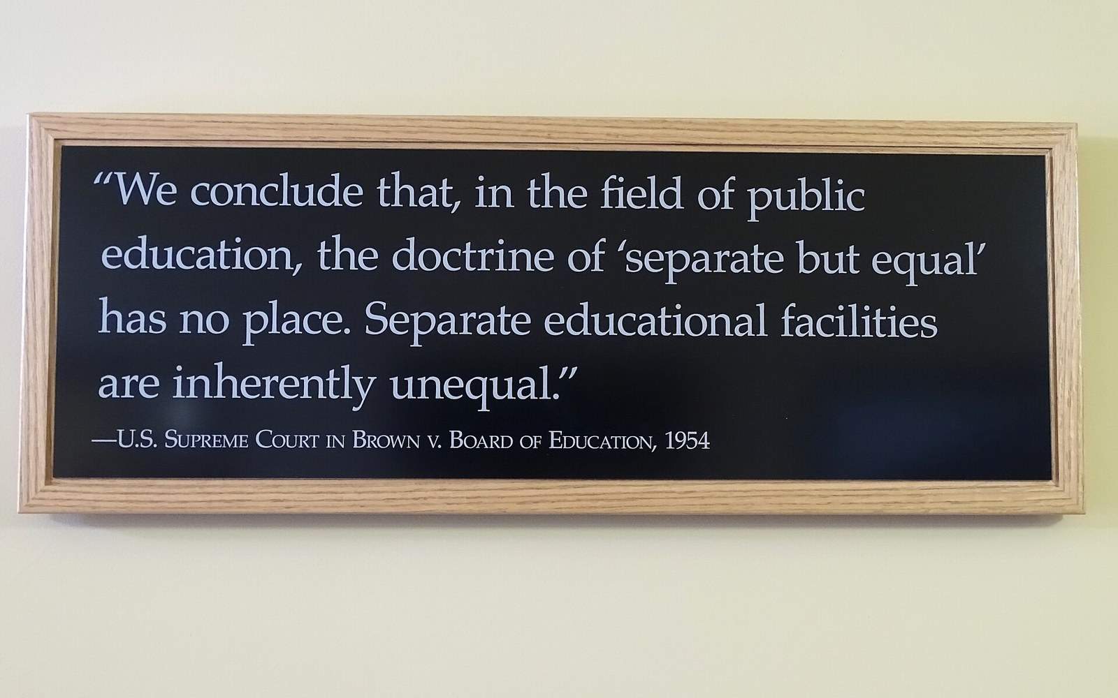 Framed wall plaque quoting the Supreme Court's Brown v. Board of Education ruling