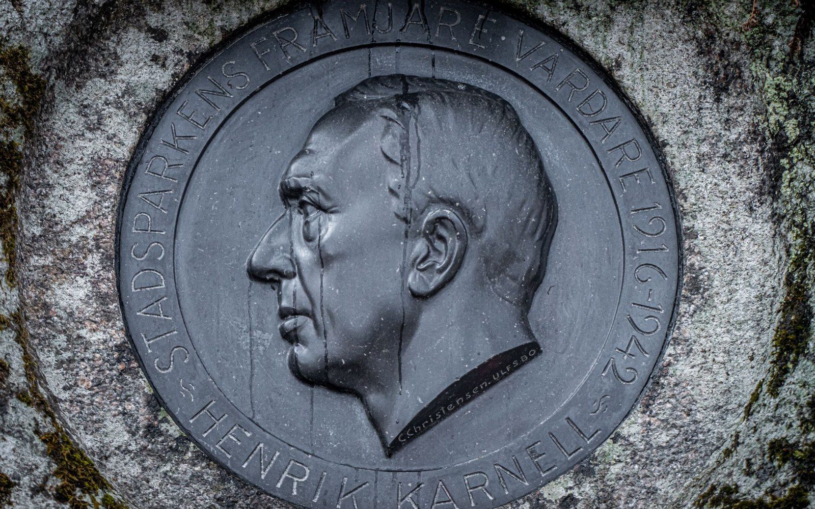 Bronze medallion profile portrait of Henrik Karnell set into weathered stone
