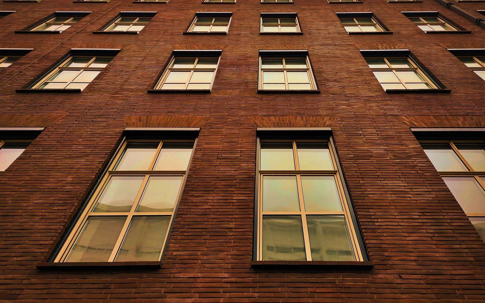 The exterior bank of south-facing windows on a surviving Rosenwald school building, brick construction, the window proportions clearly dominant in the elevation